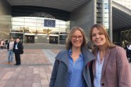 Zwei lächelnde junge Frauen vor dem EU-Parlament in Brüssel